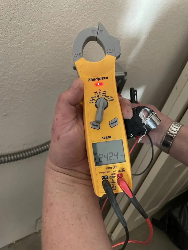 Voltage testing with clamp meter during Outlet Installation in Whispering Pines